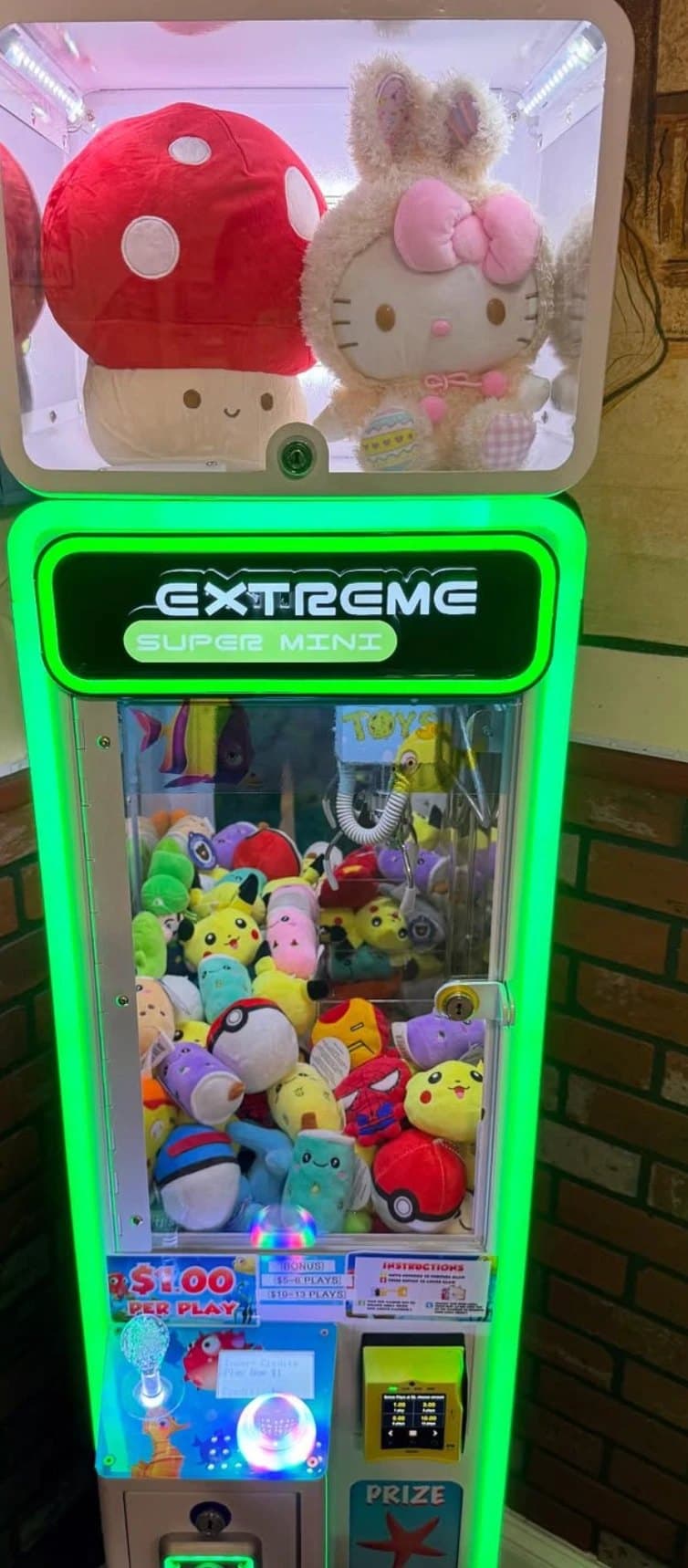 A California Claw machine stocked with plush prizes, ready for Oakland